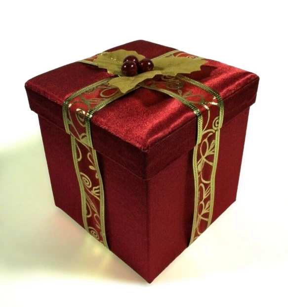 a red gift box is tied with gold ribbon