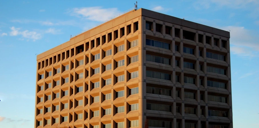 a tall building with lots of windows and two planes flying over it