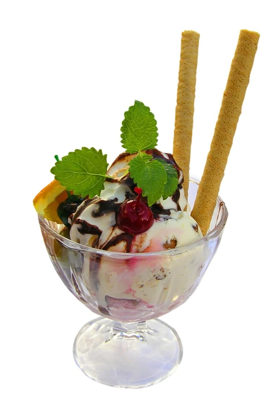 a bowl filled with ice cream and some lime leaves