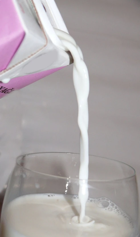 milk being poured into a glass