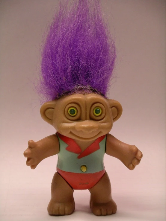 a troll with purple hair on a white background