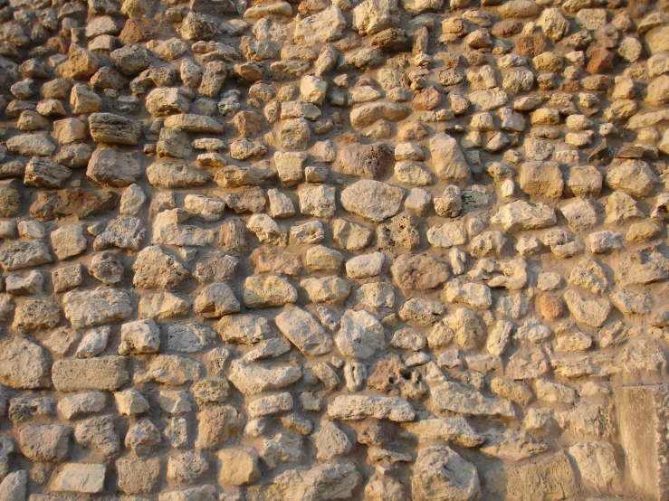 an old wall made from rocks with dirt