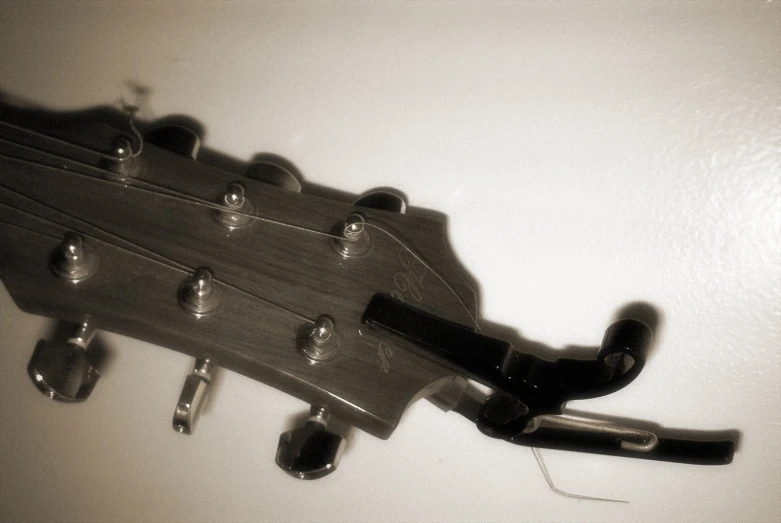 a guitar string hangs off the back of an electric guitar