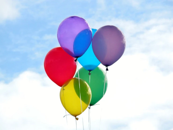 some very colorful balloons floating in the air