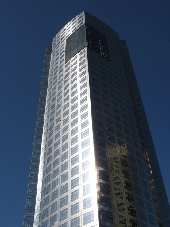 a very tall building sitting under a blue sky