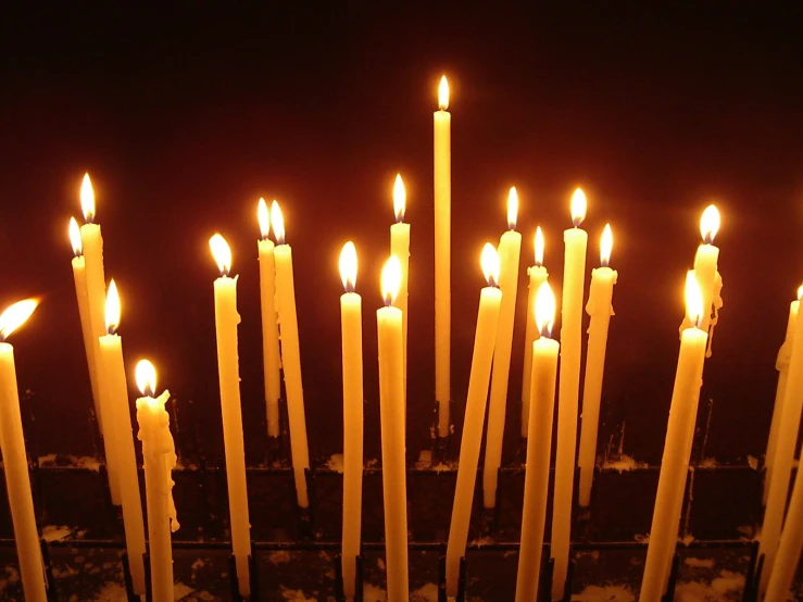 a group of candles standing in the middle of a room