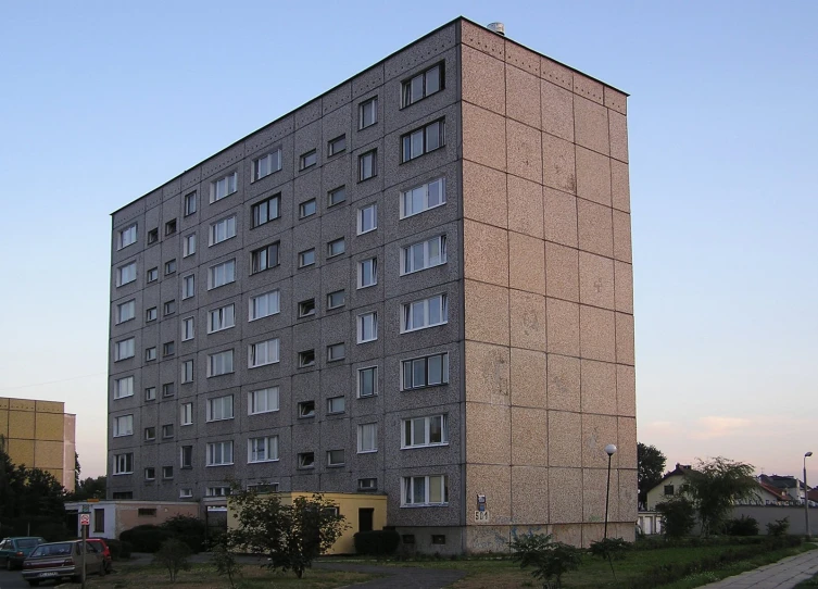 a big building made of blocks sits near the street