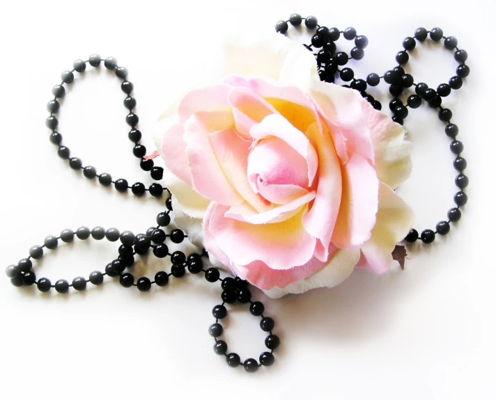 rose and bead necklace laying on a table