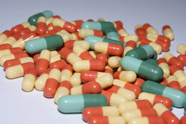 a group of pills with green and yellow stripes