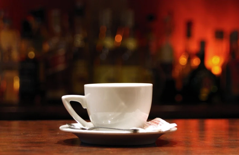 a cup and saucer sitting on top of a wooden table