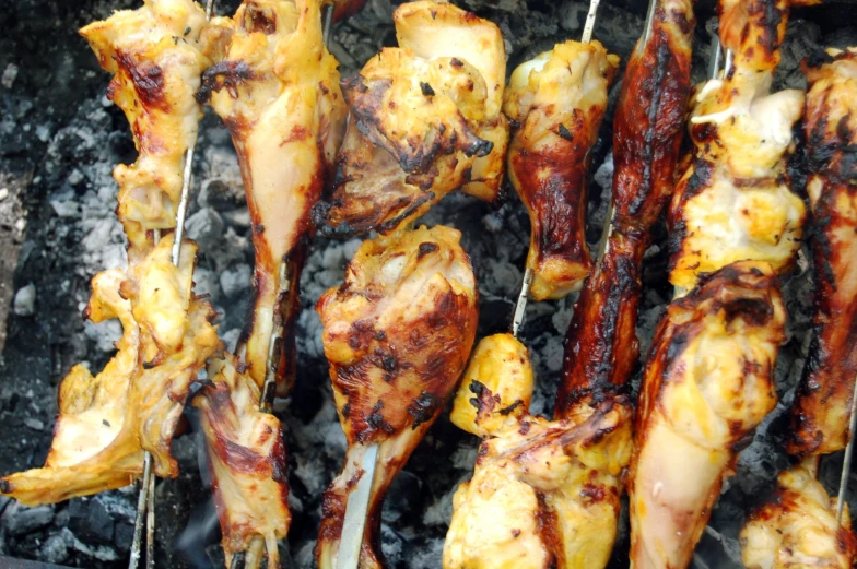 there are some barbecue chicken sitting on skewers