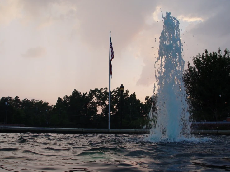 a fountain and flags blowing in the air