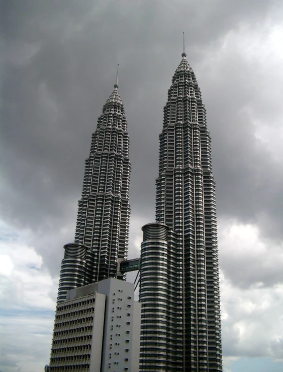 some very tall buildings under a cloudy sky