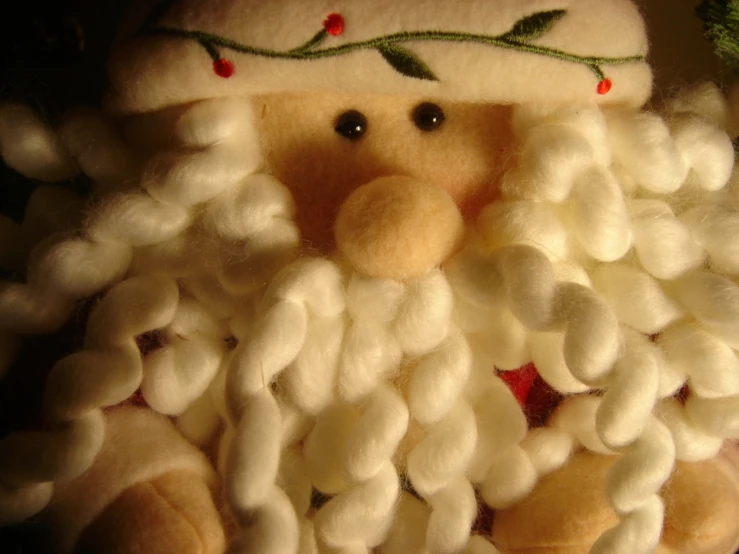 an old stuffed toy is dressed in white and has a beard