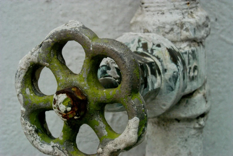 the green and white pipe is attached to the structure