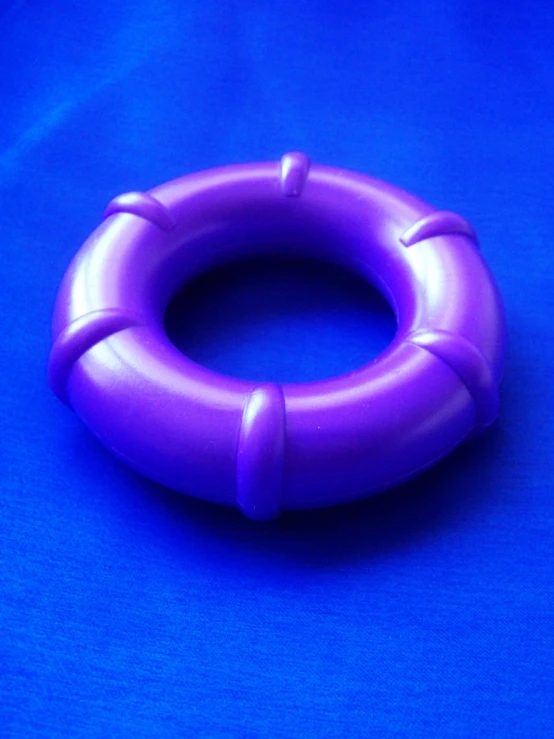 a purple ring shaped object on a blue background