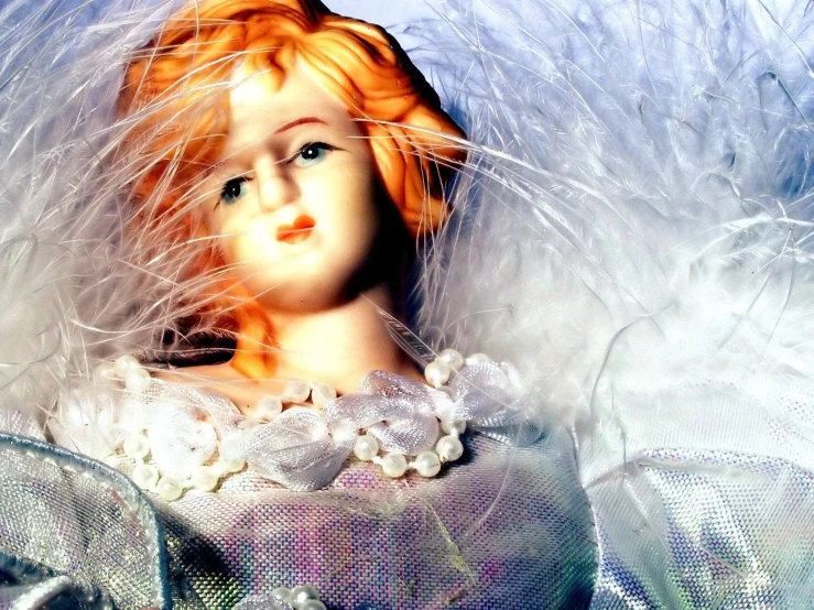 a doll with white feathers in her hair