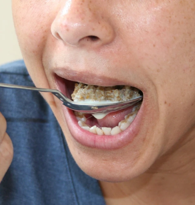 a woman is taking a bite out of a munch