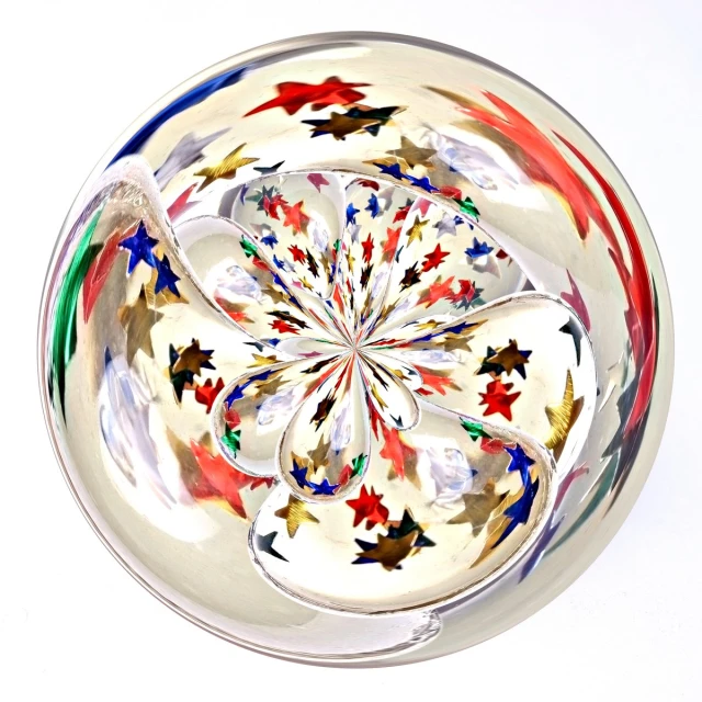 a circular glass bowl with stars and leaves on it