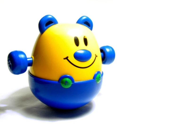 a toy with a smiley face and blue body on it