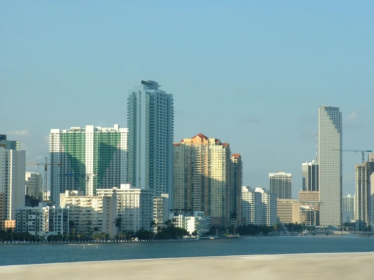 a large city with several tall buildings by the beach