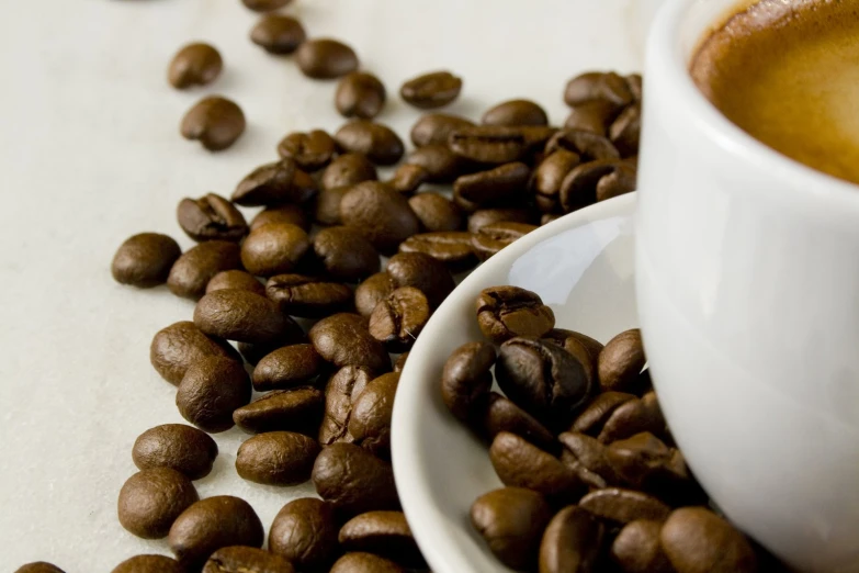 a cup of coffee with grains spilling from it