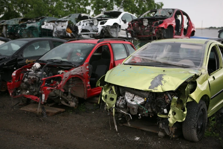 a lot of wrecked cars are shown with one missing