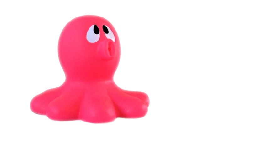 the toy figure is pink with an octo like face