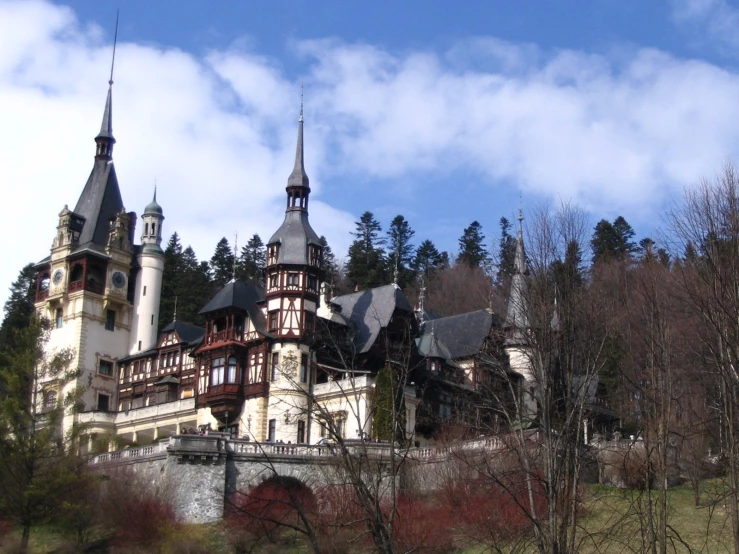 an old, brown and white building with three tall towers