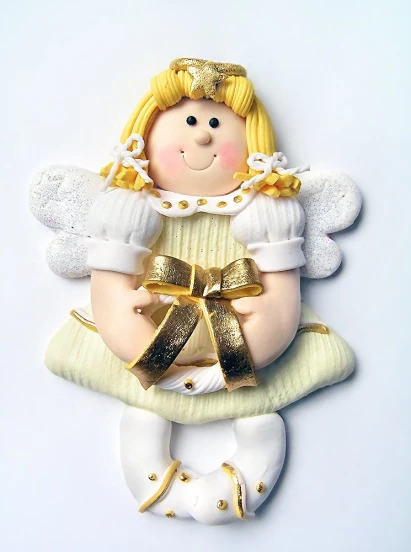 a little angel hanging ornament is being held by two hands