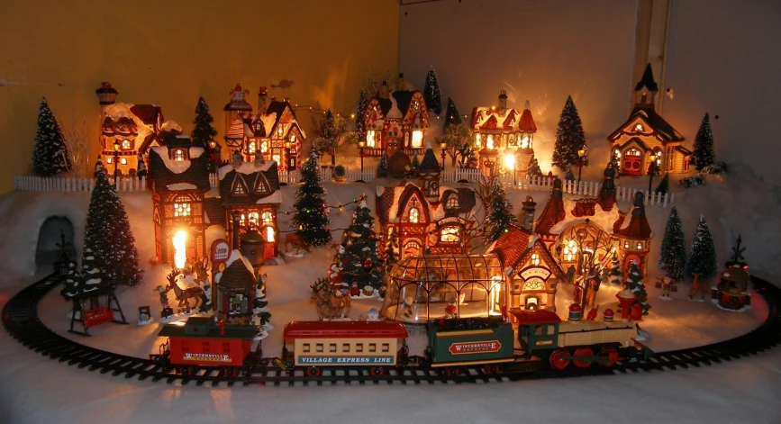 a christmas scene with a train set and many houses