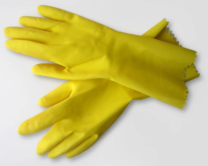 a yellow glove sitting on top of a white table