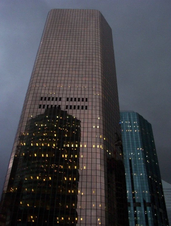 an illuminated skyscr in the city at night