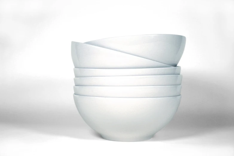 six white bowls stacked in a stack on top of each other