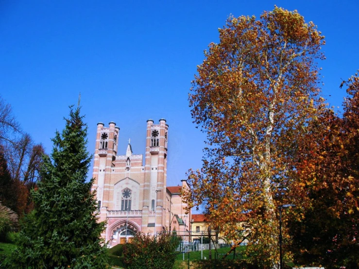 a large church and trees stand in front of it