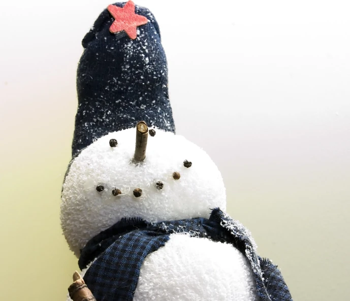 a stuffed snowman holding a bag and a baseball bat