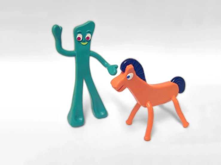 a toy pony is being petted by a toy man