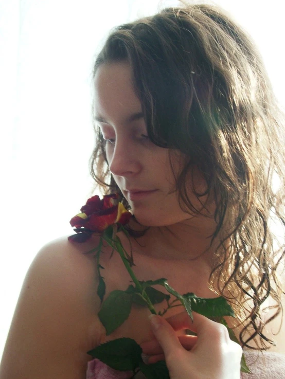 a woman that is standing in front of a curtain