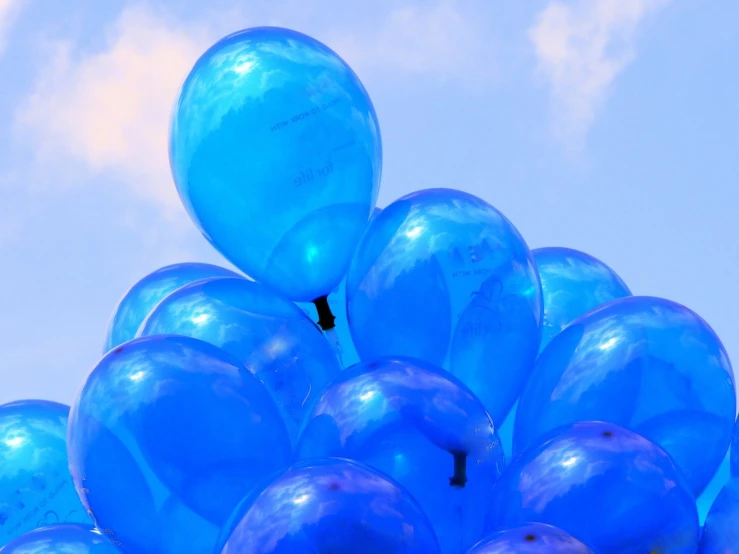 a number of balloons floating up into the sky