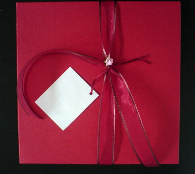 a folded red piece of paper with a red bow