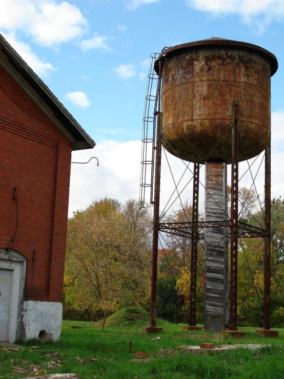 an old water tower in front of some buildings