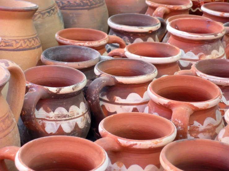 lots of different sizes and colors of clay pots