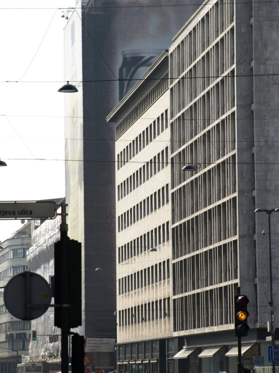 several different traffic signals in front of a tall building