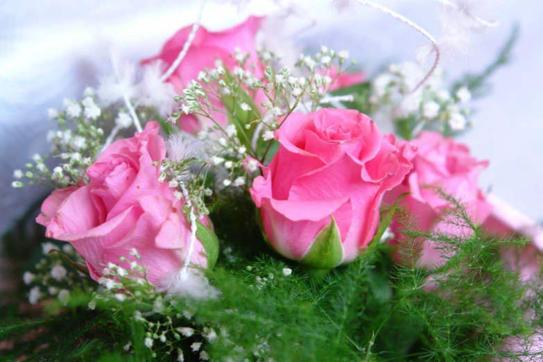 a bouquet of roses on top of a green stem