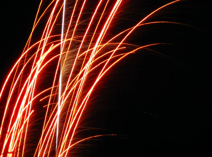 bright fireworks and streaks of red lights in the dark sky