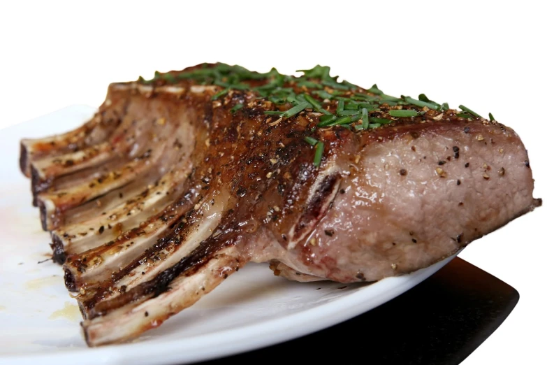 a steak on a white plate with sauce