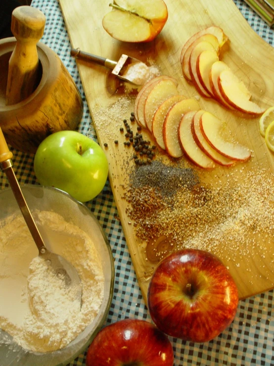 apple slices and other ingredients are on a  board