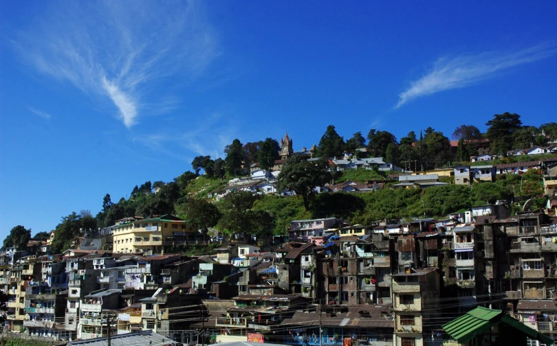 a hill area is next to a town with very tall buildings