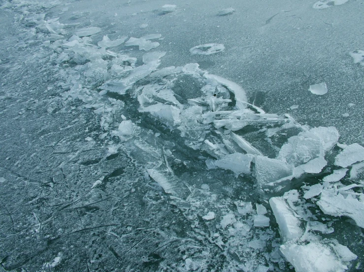 the back end of an ice covered boat on the water