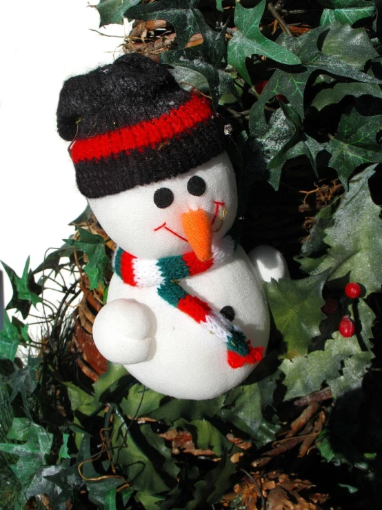 a snowman doll made of a white and red color
